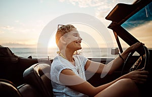 Wherever life takes you make it memorable. a happy young woman enjoying a summers road trip.