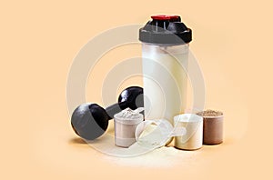 Whey or casein shake, whey smoothie with protein chocolate bar, weight training dumbbell on the side, creatine blend for muscle