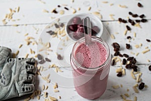 Whey protein shake with sour cherries, almonds and raisins for muscle building workout with fast and complex carbohydrates