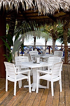 Whie plastic chairs and tables on the patio