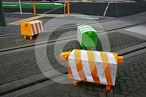 Three blocky animal sculptures. Colorful sheep traffic safety bollards on road with tramway tracks in Christchurch, New Zealand