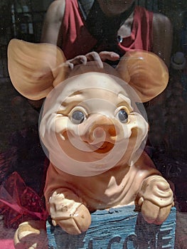Whimsical pig statue in window