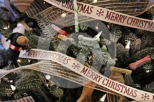 Whimsical puppy themed Christmas tree covered with dogs, bones, and ribbon that wishes one a `Merry Christmas.`