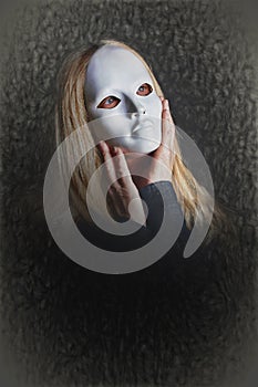 Woman Hiding Her Face With A Mask  photo