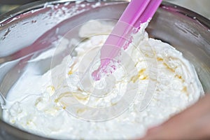 whipped cream cooking process.woman mixing Fresh cream for making whipped cream or desserts and bekery.woman making whipped cream