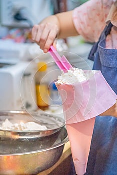 whipped cream cooking process.woman mixing Fresh cream for making whipped cream or desserts and bekery.woman making whipped cream