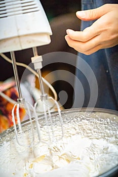 whipped cream cooking process.woman mixing Fresh cream for making whipped cream or desserts and bekery.woman making whipped cream