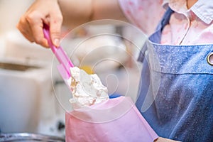 whipped cream cooking process.woman mixing Fresh cream for making whipped cream or desserts and bekery.woman making whipped cream