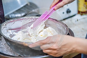 whipped cream cooking process.woman mixing Fresh cream for making whipped cream or desserts and bekery.woman making whipped cream