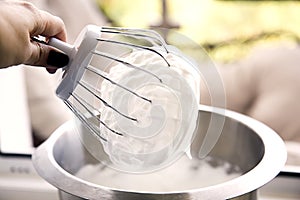Whipped egg whites for cream on mixer whisk photo