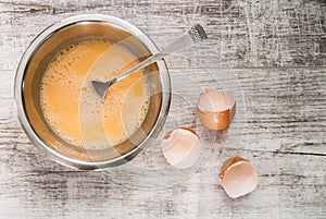 Whipped eggs on wood table. Top of view.