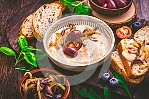 Whipped feta cheese dip with garlic, olives, lemon and caramelized onions