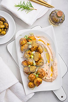 Whipped feta, ricotta, cheese dip (Tirokafteri) with crispy baked potatoes and grilled olives