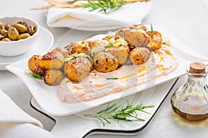 Whipped feta, ricotta, cheese dip (Tirokafteri) with crispy baked potatoes and grilled olives