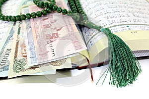 Whipped Quran with afghanistanischer currency