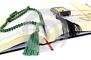 Whipped Quran with green rosary
