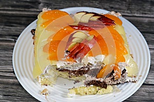 whipped vanilla cream, slices of pineapples, apples, peach and nuts from a birthday cake of three different pieces spongy creamy