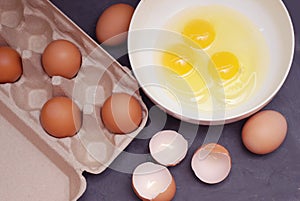 Whipping Chicken Eggs. Yolks and Egg protein in a Cup. Preparation of Food and Chicken Eggs. Eggshell on a cutting board. Top View