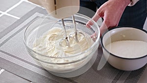 Whipping cream cheese in a glass bowl