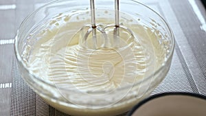 Whipping cream cheese in a glass bowl