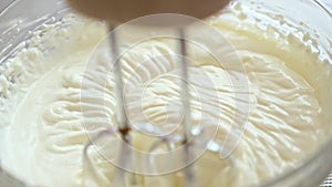 Whipping cream cheese in a glass bowl