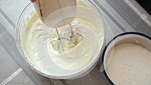 Whipping cream cheese in a glass bowl