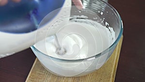 Whipping cream in mixing bowl. Making cream. Baking ingredients