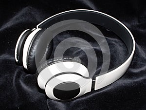 Whireless white Headphones on a Black Background