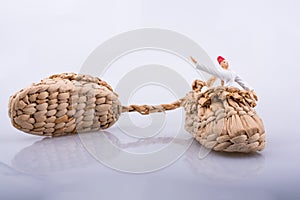 Whirling dervish riding in a straw shoe on white background