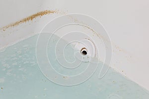 Whirlpool tub or jetted bathtub with dirty water.