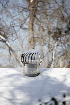 Whirlybird Air Vent on a Snowed-Over Roof