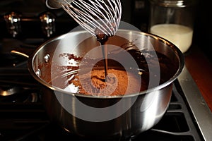 whisk stirring hot chocolate in a saucepan