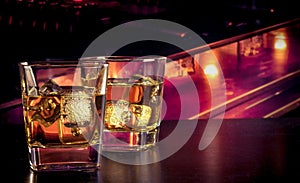 Whiskey on bar table with ice