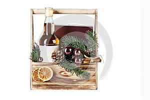 Whiskey bottle, Christmas tree decorations in a wooden box. New Year`s gift set. Isolated on white background. Space for text