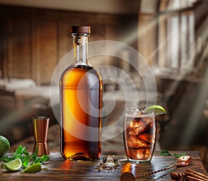 Whiskey bottle and glass of whiskey gleamed in the sun lights from window are on the old wooden table. Blurred interior of pub at