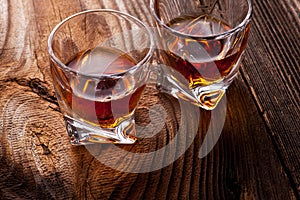 Whiskey, bourbon, brandy, or cognac on log table