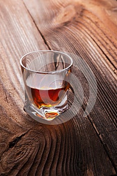 Whiskey, bourbon, brandy, or cognac on log table