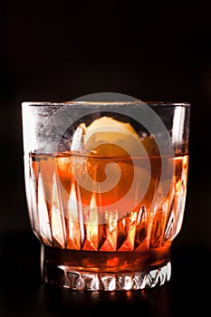 Whiskey and campari cocktail garnished with orange peel