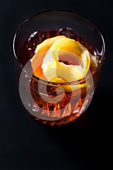 Whiskey and campari cocktail garnished with orange peel