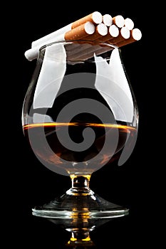 Whiskey in a classic glass and cigarettes