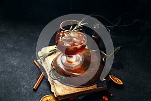 Whiskey cocktail with ice and burnt rosemary
