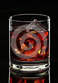 Whiskey glass on black background photo