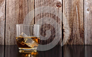 Whiskey glass with ice cubes.