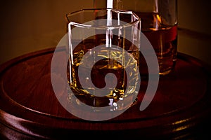 Whiskey glass on wooden tray