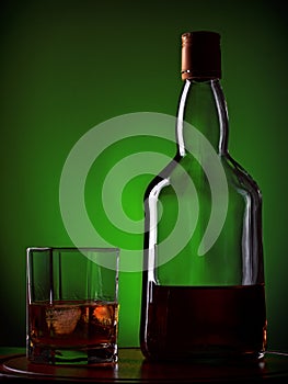 Whiskey and glass on wooden tray