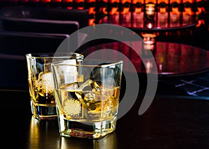 Whiskey glasses with ice in a lounge bar