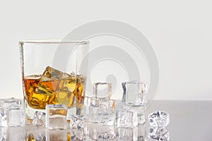 Whiskey with ice cubes on white background