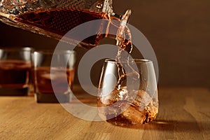 Whiskey is poured into a dammed glass with ice