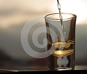 Whiskey pouring into shot glass