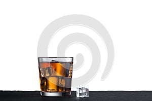 Whiskey on the rocks in glass isolated over white background with copy space